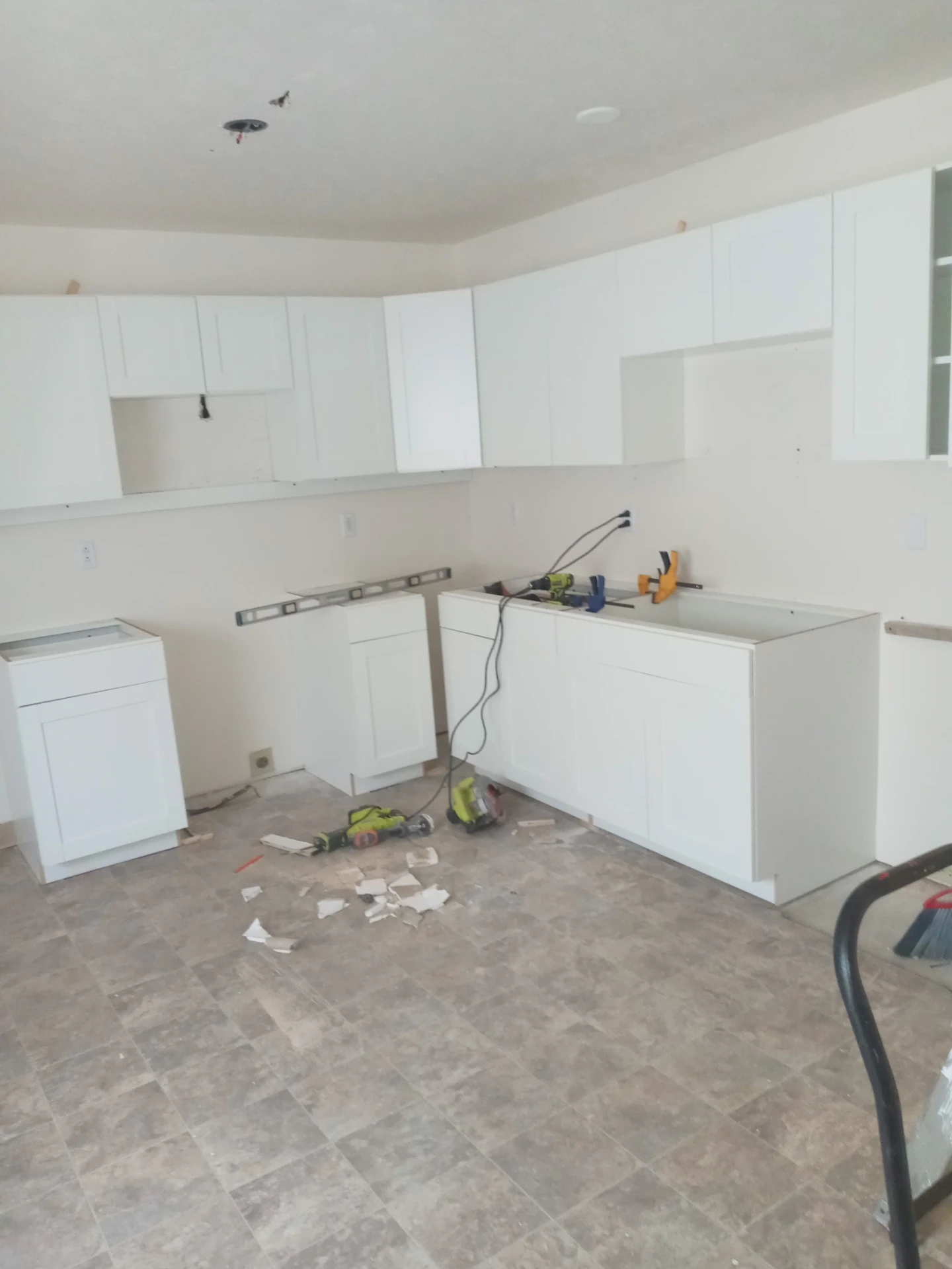 Kitchen cabinet installation with new tile flooring