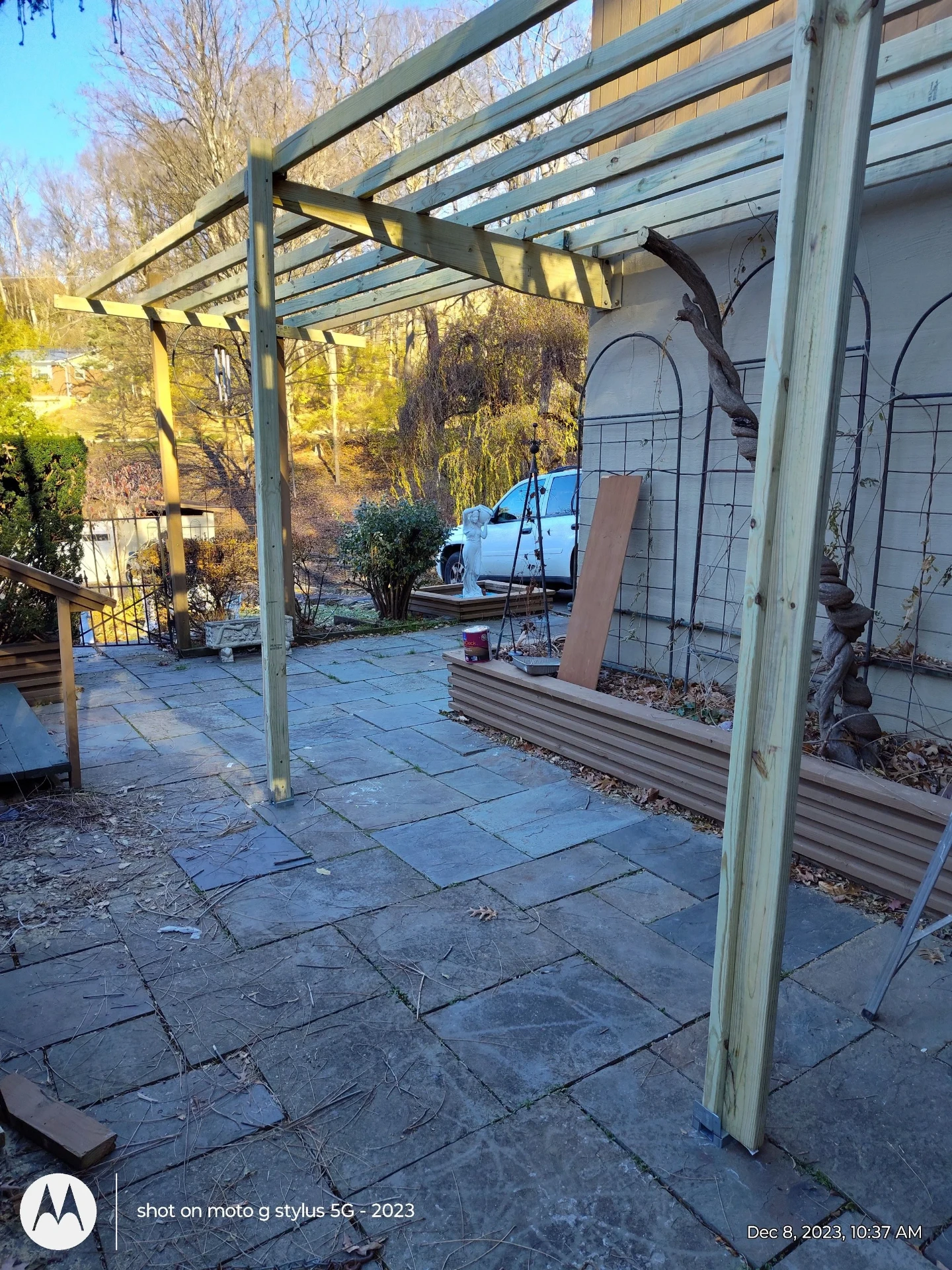 Custom wooden pergola built in a backyard patio